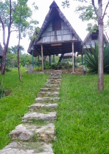 Thatch roof cottages on stilts provide rustic overnight lodging to visitors.